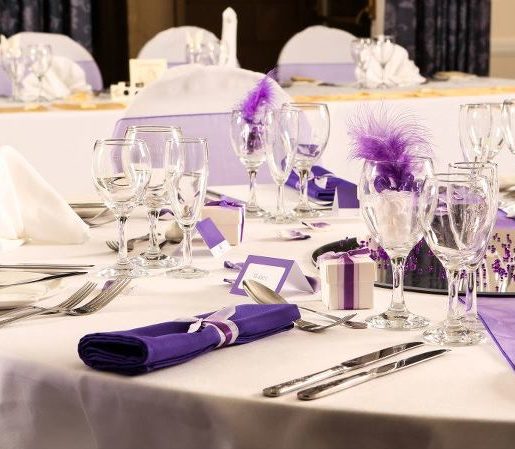 Table dressed with purple themed place settings for a wedding at Mercure hotels