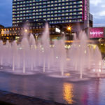 The front of mercure manchester piccadilly hotel as seen from the fountain in piccadilly gardens in manchester