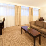 Desk, sofa and double bed in a privilege room at mercure manchester piccadilly hotel