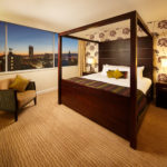 Four poster bed with nighttime picture window view in a superior room at mercure manchester piccadilly hotel
