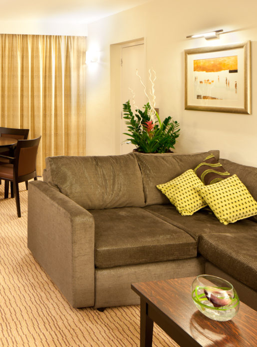 Sofa, desk, table and chairs in a superior room at mercure manchester piccadilly hotel