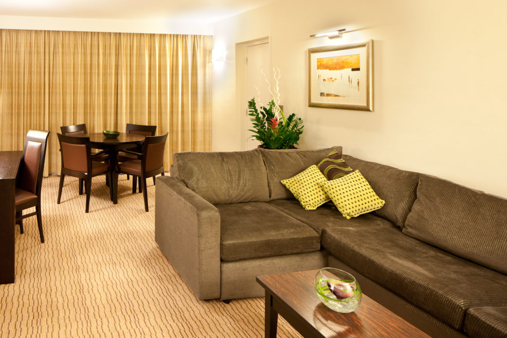Sofa, desk, table and chairs in a superior room at mercure manchester piccadilly hotel