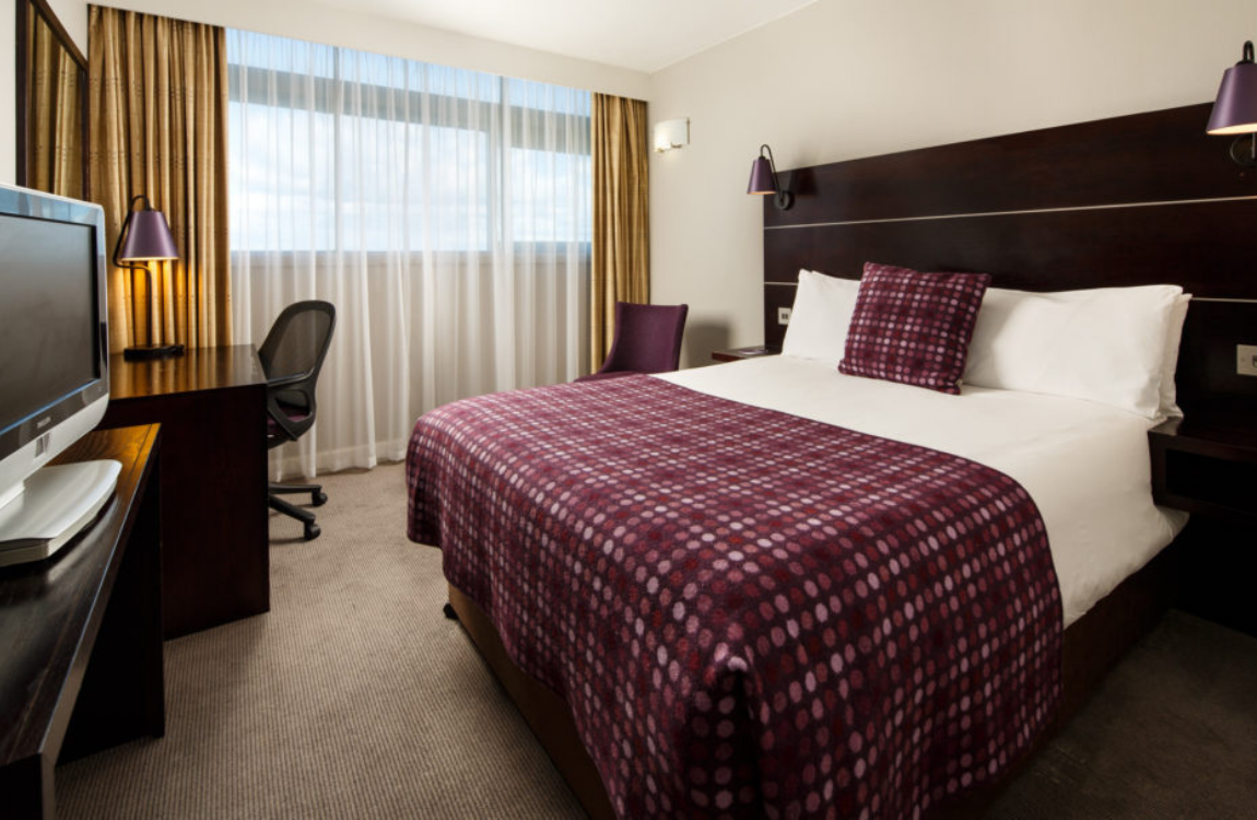 Desk, sofa and double bed in a privilege room at mercure manchester piccadilly hotel